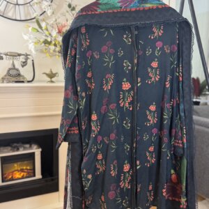Back view of a blue floral 3 piece suit with a floral design and colorful neckline.