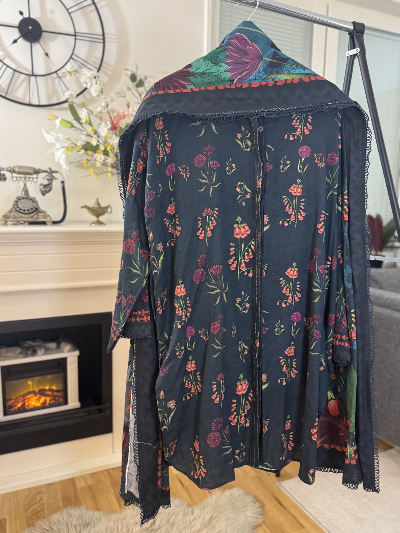 Back view of a blue floral 3 piece suit with a floral design and colorful neckline.