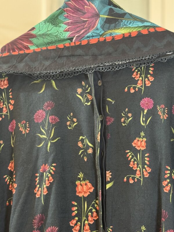 Close-up of the floral design on the back of the blue suit.