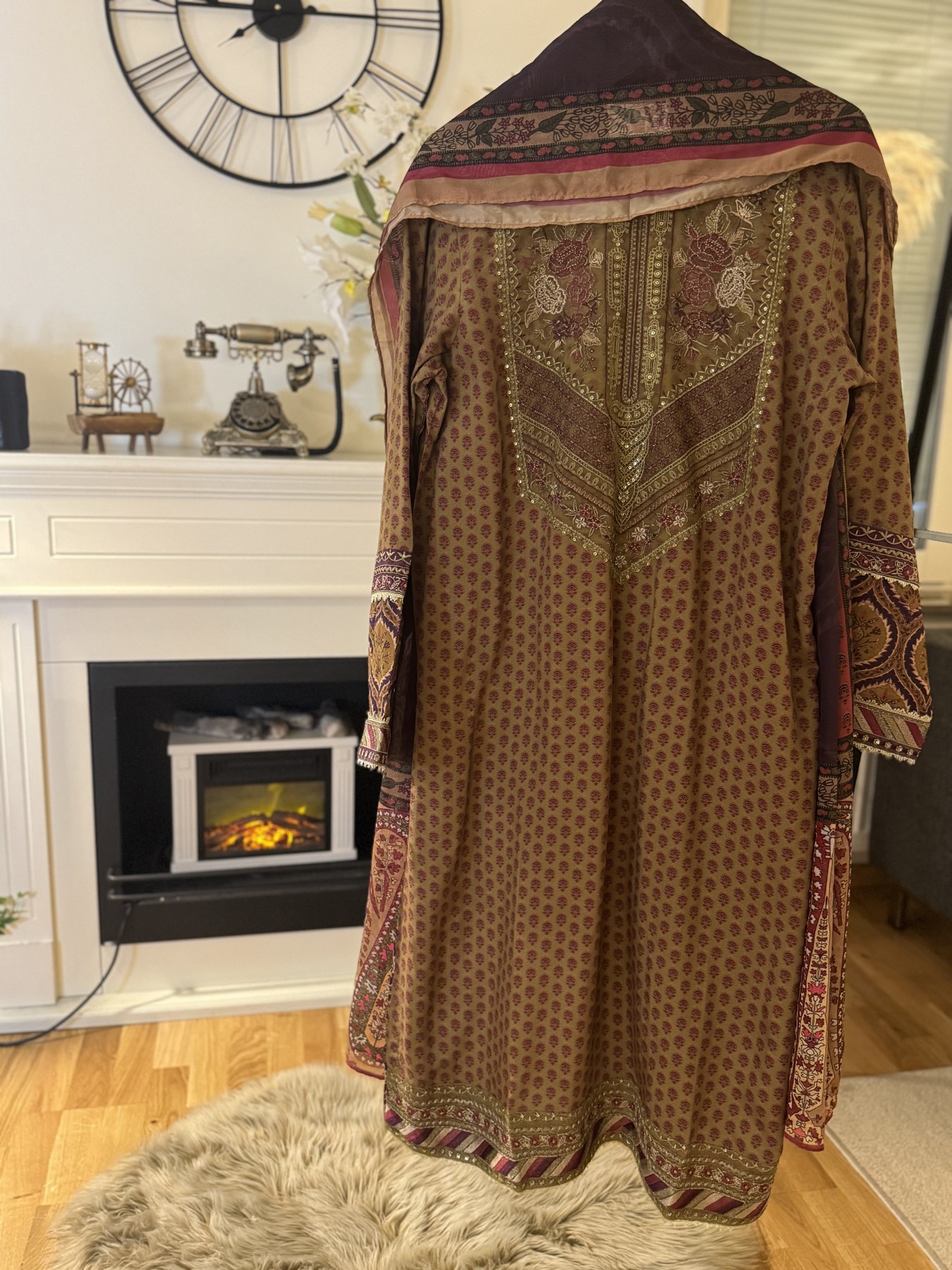 Back view of a khaki 3 piece suit with intricate embroidery and a silk dupatta.