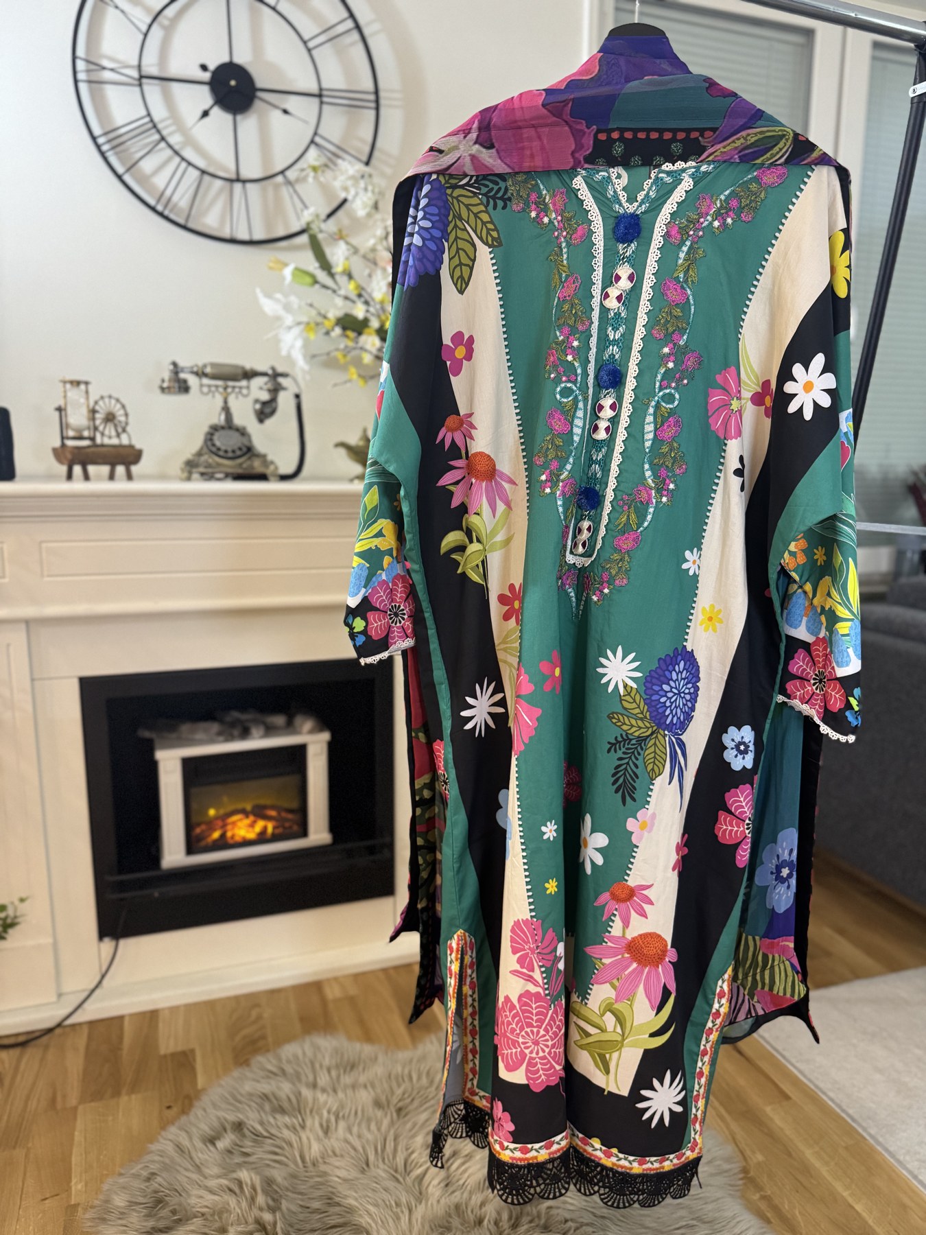 Back view of a green 3 piece suit with floral embroidery and a dupatta