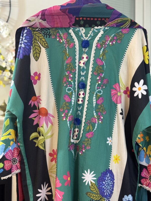 Close-up of the embroidered shirt with floral designs and buttons