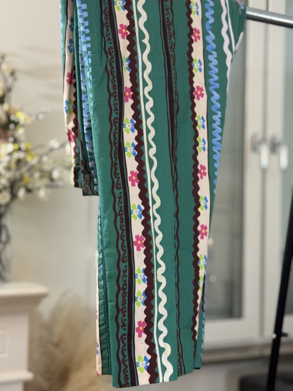 Side view of the striped trousers in green and floral patterns